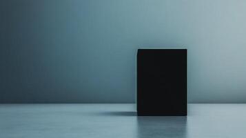 Mysterious black cube standing alone in a minimalist space with soft lighting during twilight hours photo