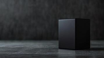 Elegant minimalism with a sleek black cube on a textured surface in soft light showcasing simplicity and design photo