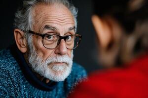 Intimate conversation between a wise elder and a curious young person in a cozy indoor setting photo