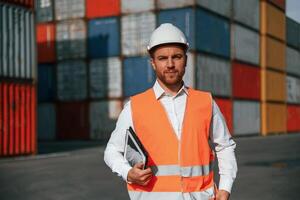 Front ,view. Male worker is on the location with containers photo