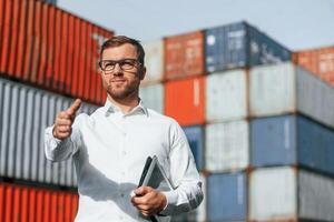 Giving, hand to make handshake, successful deal. Male worker is on the location with containers photo