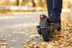Close up, view of eletric scooter that is riding by a man on the road photo