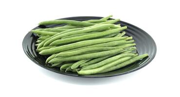 Fresh Green Beans Nicely Arranged on a Minimalistic Black Plate photo