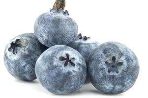 A vibrant macro shot captures the exquisite detail of a cluster of fresh blueberries. photo