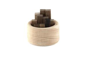 A collection of brown wooden blocks arranged in a circular container, showcasing natural textures. photo