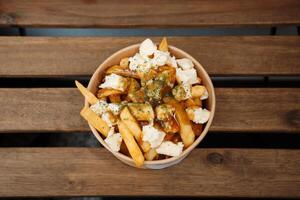 Poutine fries with chees and sauce photo
