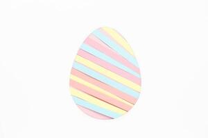 Paper strips in egg shape on white background photo