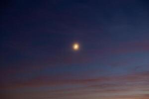 Crescent moon on the hazy sky. photo