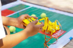 Asian students sit together with friends from the Robotics Club. Assemble the parts of robot car. Soft and selective focus. photo
