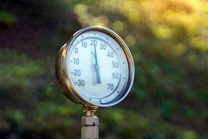A thermometer with a circular display is installed at a weather station on a mountaintop in northern Thailand. photo