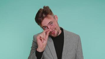 Business man showing little bit gesture with sceptic smile showing minimum sign measuring small size video