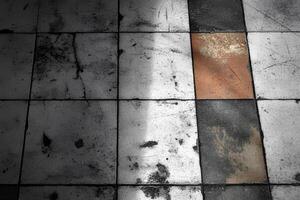 Detailed view of an old tile floor texture with shadows creating an abstract and textured design photo