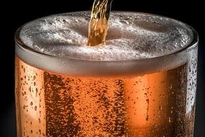 Close-up of beer being poured into a glass, with a dark background creating a dramatic and refreshing atmosphere photo