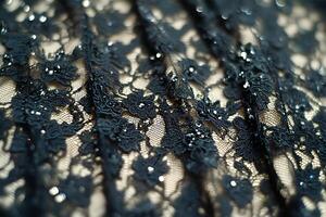 Close-up of black lace texture, a fine open fabric made by looping, twisting, or knitting thread into intricate patterns photo