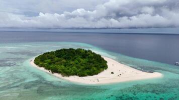 Aerial drone exploration of Mantique Island Philippines Camiguin. Small tropical island white sands clear waters video