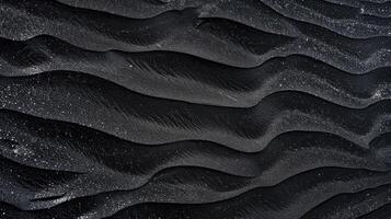 A black sand beach with waves and water photo