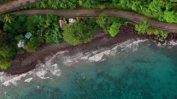 Aerial view sunrise rugged tropical coastline and lush jungle blue ocean Philippines Asia road video