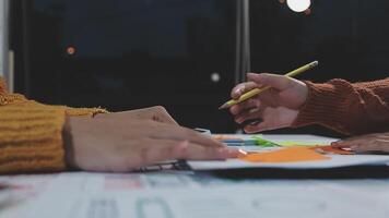Two people working on a project at a table video