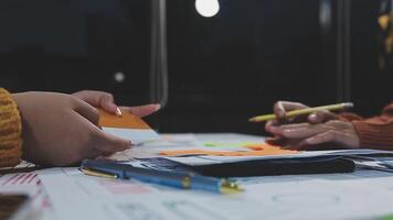 Two people working on a project at a table video