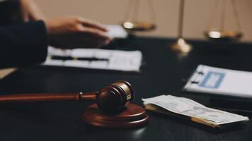 A judge's gavel and money on a desk video