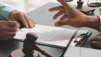 A lawyer signing a contract with a client video