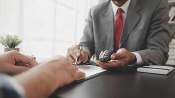 A man in a suit is signing a contract with another man video
