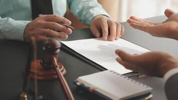 A lawyer and a client signing a contract video