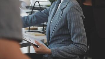 A woman in a business suit is holding a clipboard video