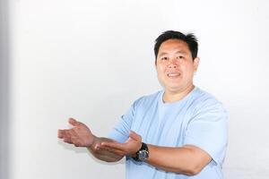 Smiling Man Presenting something with both hands opened photo