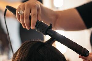 Close-up of a hair curler with which someone is making waves photo