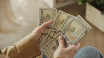 Counting stack of hundred dollar bills in hands video