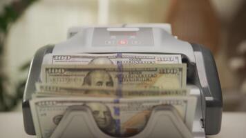 Hand Adjusting Stack of US Dollar Bills in Money Counting Machine video