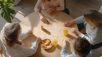 Four people playing cards at a table photo