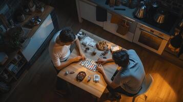 Two people playing a board game in a kitchen photo