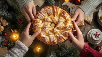 Hands reaching for a pastry on a table photo
