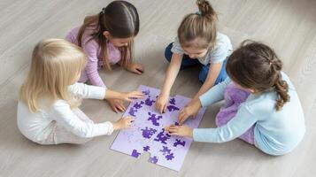 Four little girls playing with a puzzle on the floor photo