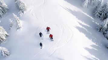 Three people are skiing down a snowy slope photo