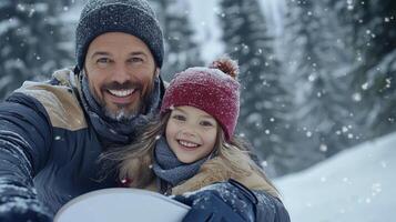 A man and a little girl are taking a selfie in the snow photo
