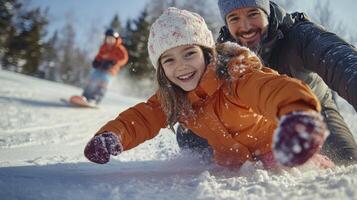 A man and a young girl are having fun on the snow photo