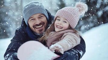 A man and a little girl are having fun in the snow photo