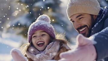 A man and a little girl are having fun in the snow photo