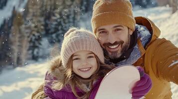 A man and a little girl are taking a selfie in the snow photo