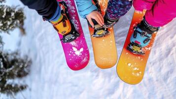 Three people standing on snowboards with their feet on the ground photo