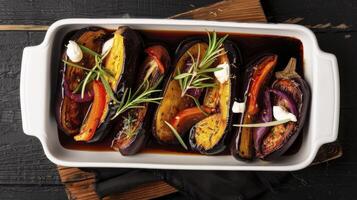 A dish with eggplant, peppers and cheese photo