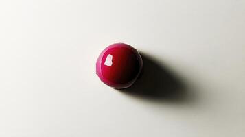 A red and pink object on a white surface photo