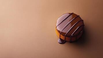 Chocolate cake with drizzle on brown background photo