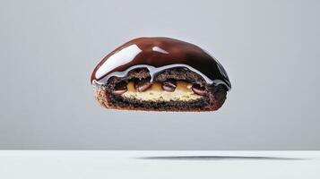 A chocolate covered doughnut with a peanut butter filling photo