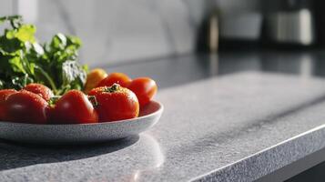 A bowl of tomatoes on a counter top photo