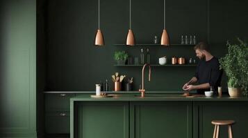 A man is standing in front of a green kitchen photo