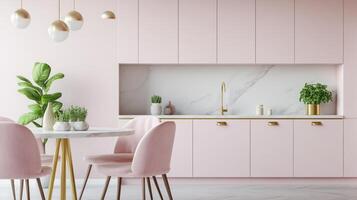 A pink kitchen with gold accents and a white table photo